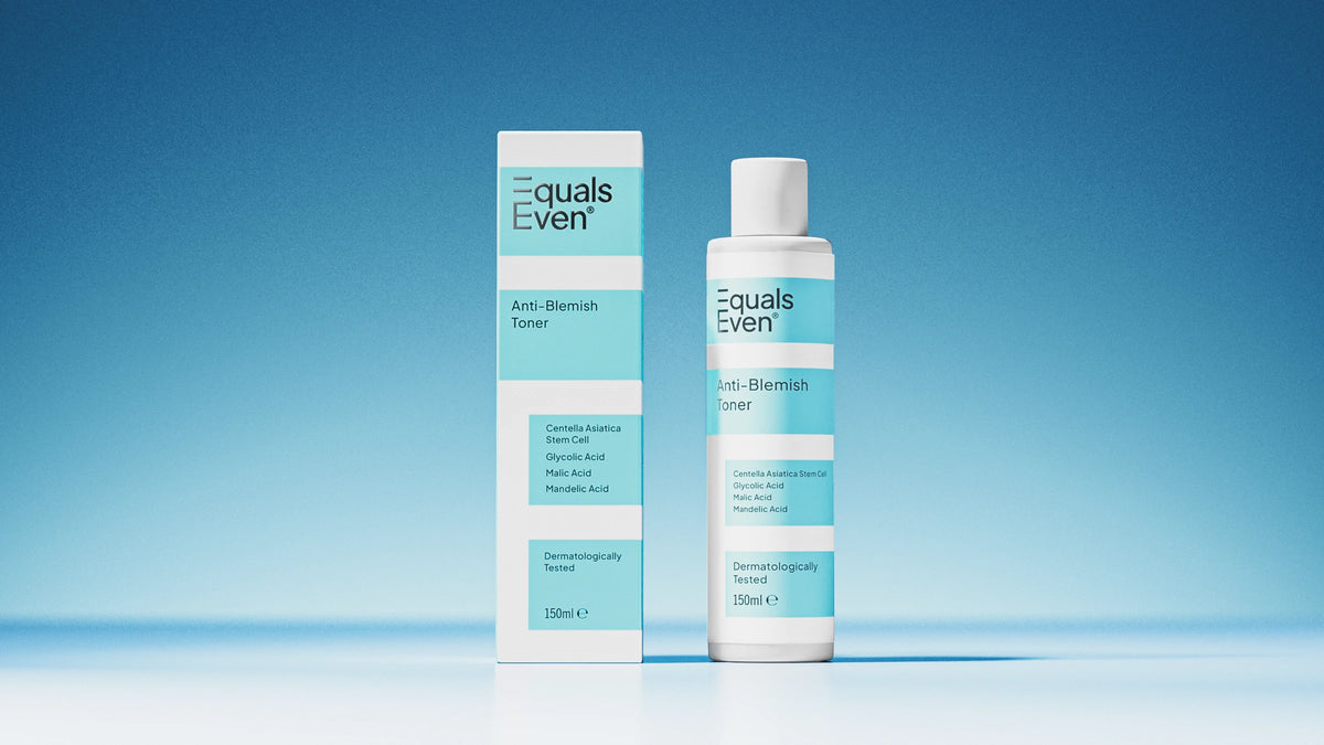 A bottle and box of Anti Blemish Toner, featuring white packaging with light blue accents and product details, are shown against a blue gradient background. This toner is designed to unclog pores and promote glowing skin.