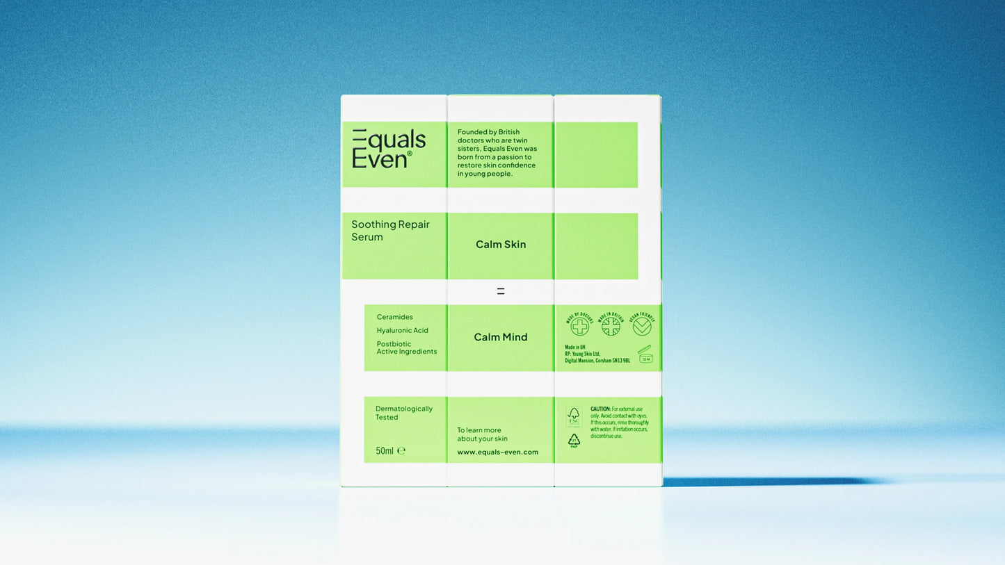 A green and white box labeled Soothing Repair Serum stands against a blue background. The minimalist packaging highlights postbiotic serum benefits to soothe stressed skin, shown in bright, clean lighting.