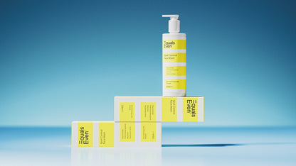 A white pump bottle labeled Spot Control Face Wash—a gentle cleanser that removes impurities—stands on three matching yellow-and-white boxes, all arranged creatively against a blue gradient background.