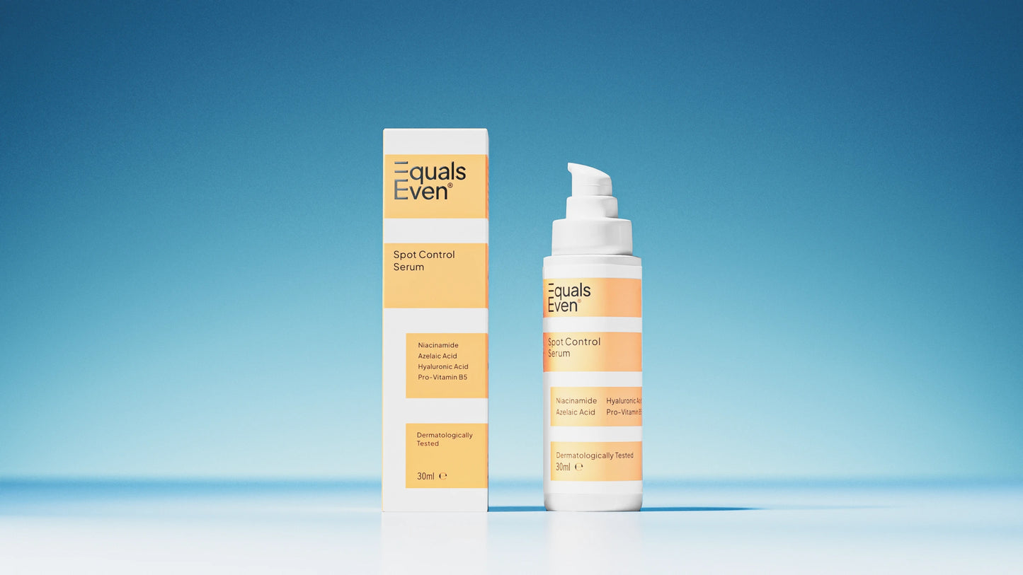 A bottle and box of Spot Control Serum, a potent blemish treatment in yellow and white packaging, are shown against a blue background. The label emphasizes breakout-fighting ingredients to help reduce post-blemish marks.
